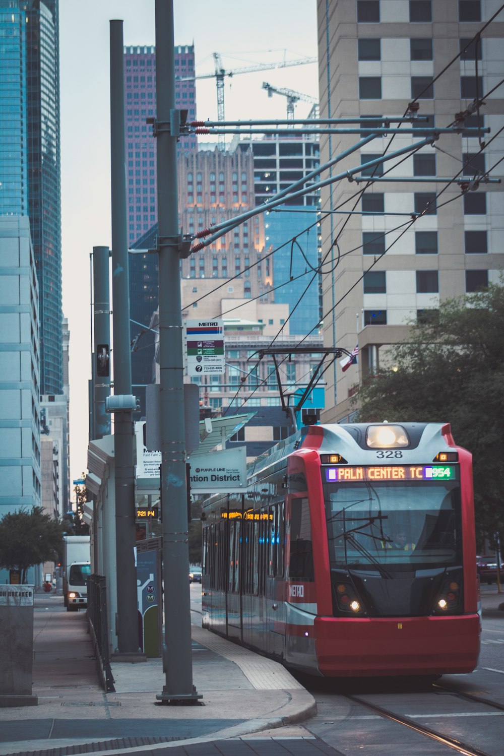 green and yellow tram on road during daytime