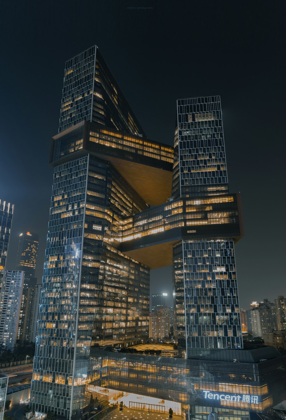 a very tall building in the middle of a city at night