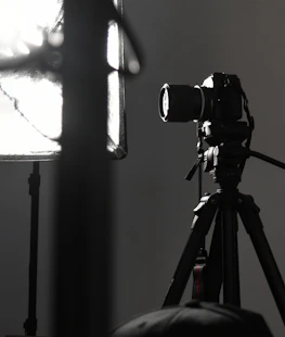 An elegant editorial studio setup with soft lighting and a large-format camera poised for a shoot.