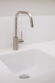 A modern, minimalist kitchen sink with a white splash pad will emphasize functionality.