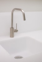 A sleek and functional kitchen sink with accessories.