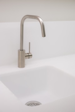 A modern kitchen with updated sinks and fixtures.