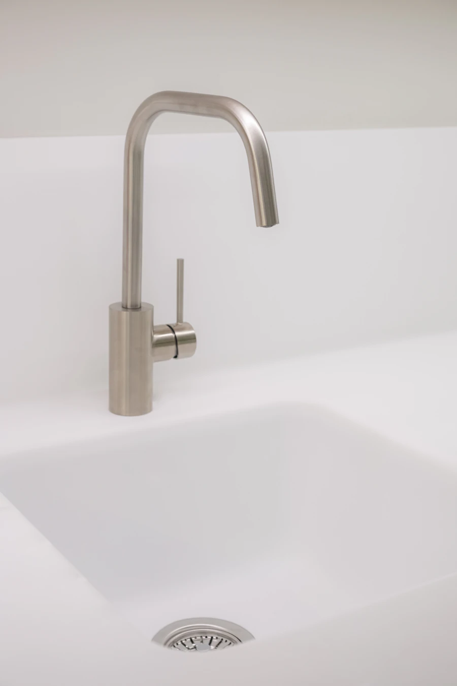 Modern kitchen faucet on a white sink