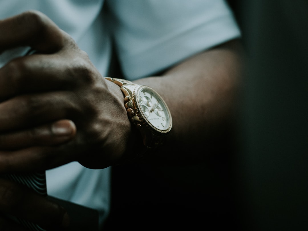 person wearing silver and gold chronograph watch