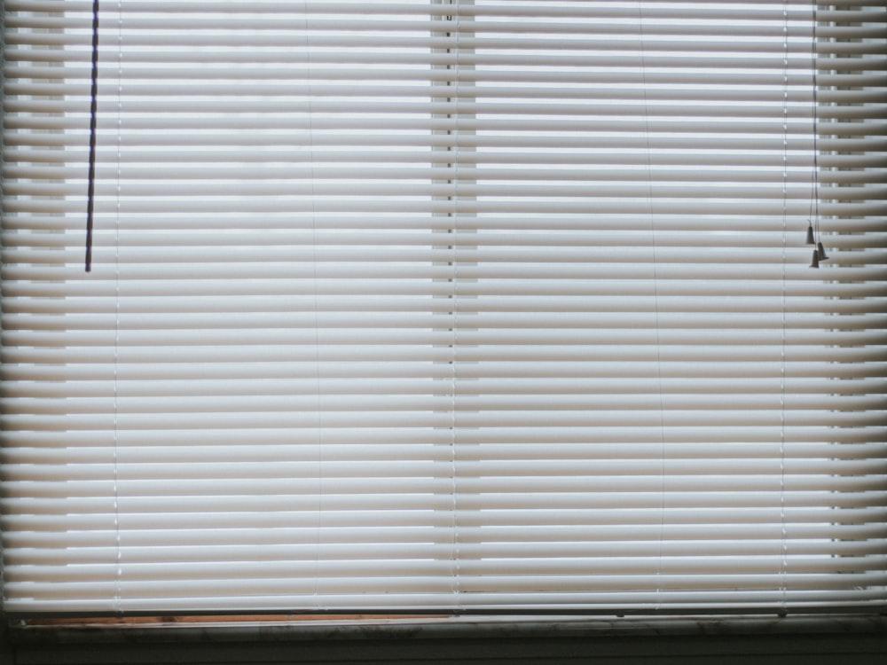 white window blinds during daytime