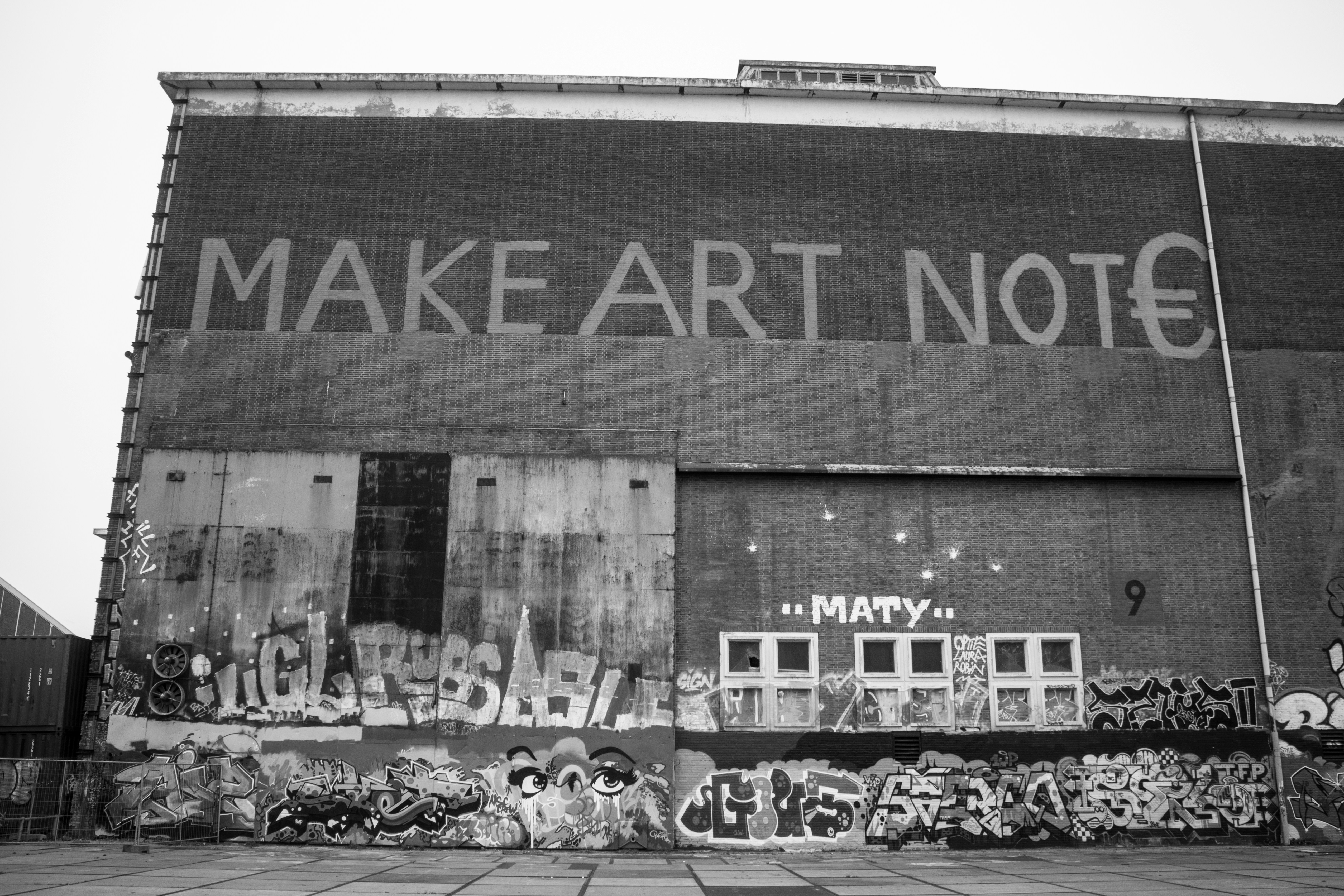 a black and white photo of a building with graffiti on it