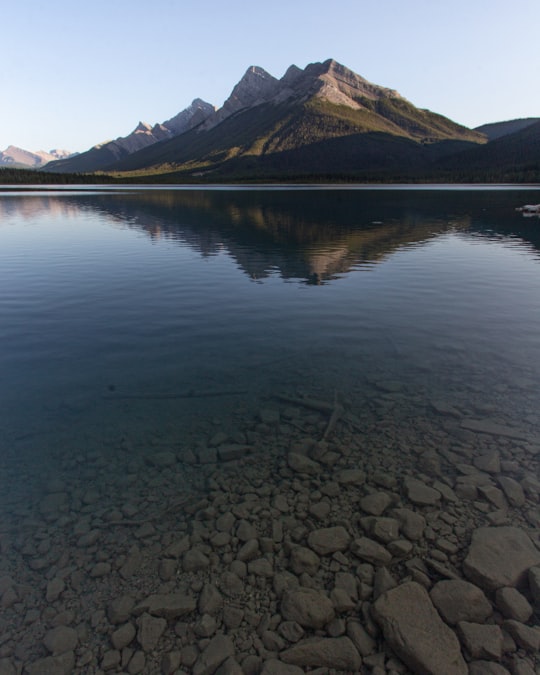 lake near mountain during daytime in Bow Valley Provincial Park - Kananaskis Country Canada