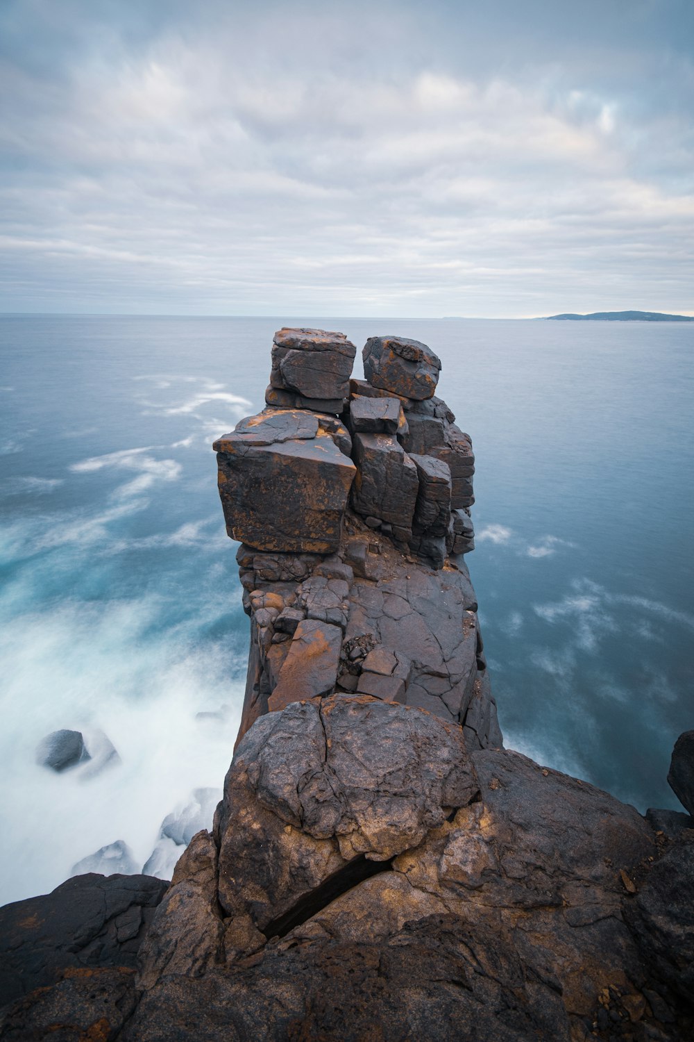 brown rock formation on sea during daytime