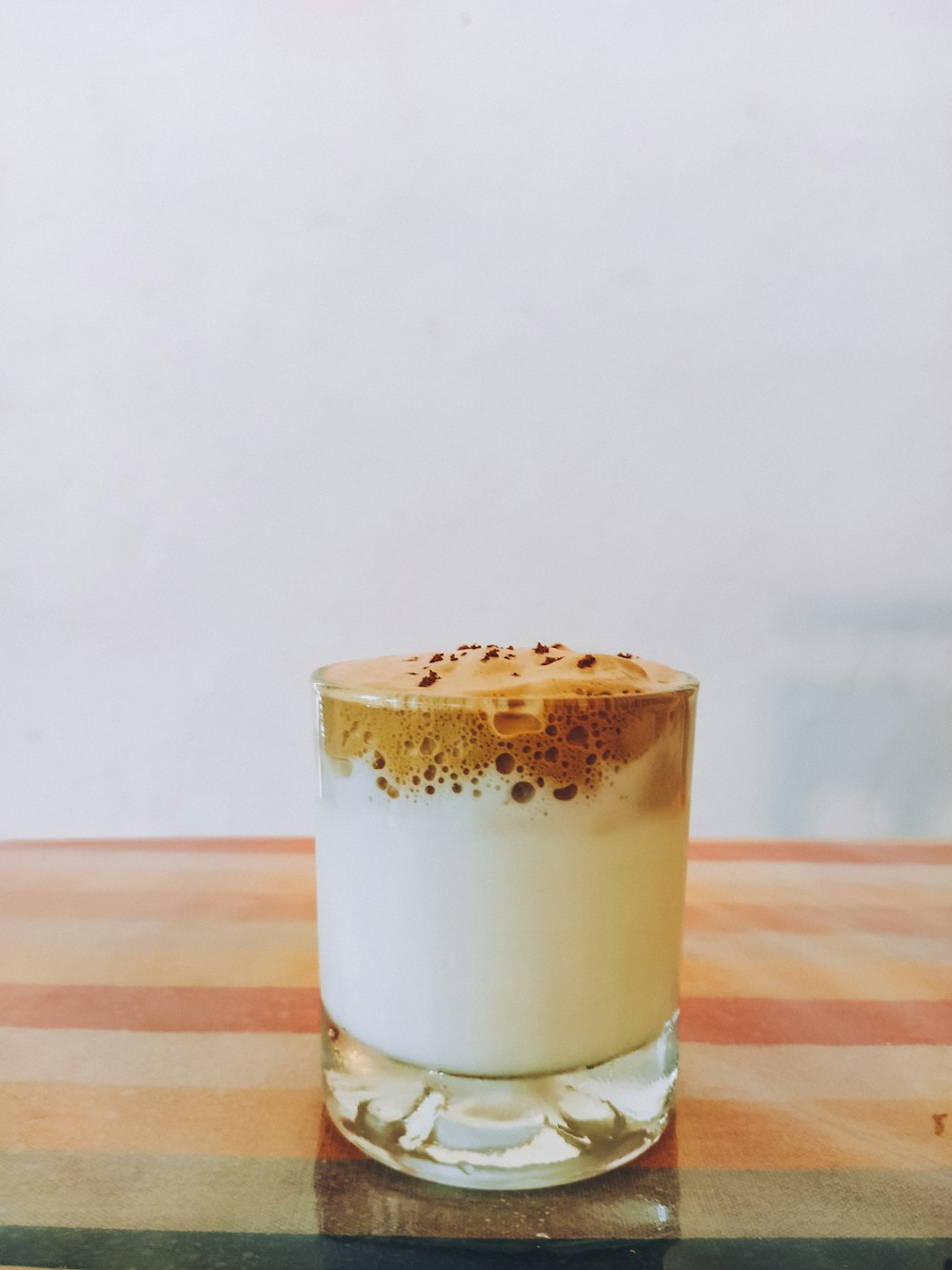 clear drinking glass with white liquid