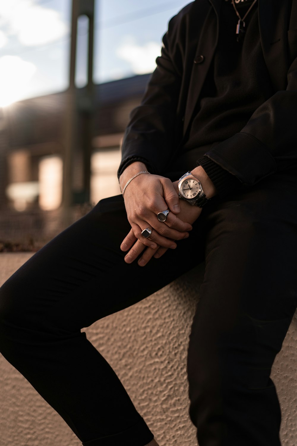 person wearing black pants and silver watch