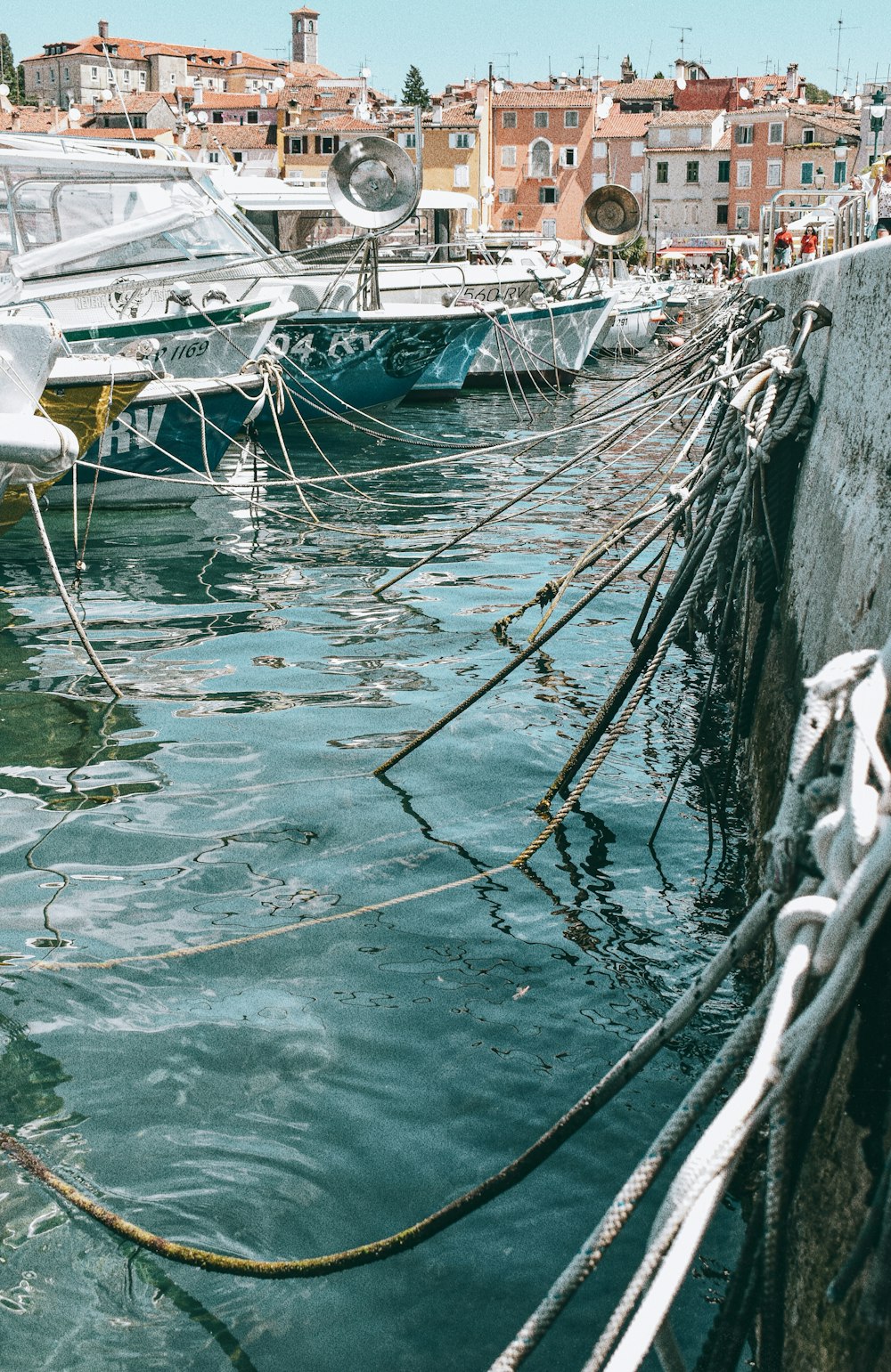 white and blue boat on water during daytime