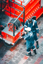 Technician in blue uniform using water extraction equipment in a flooded Brooklyn home.