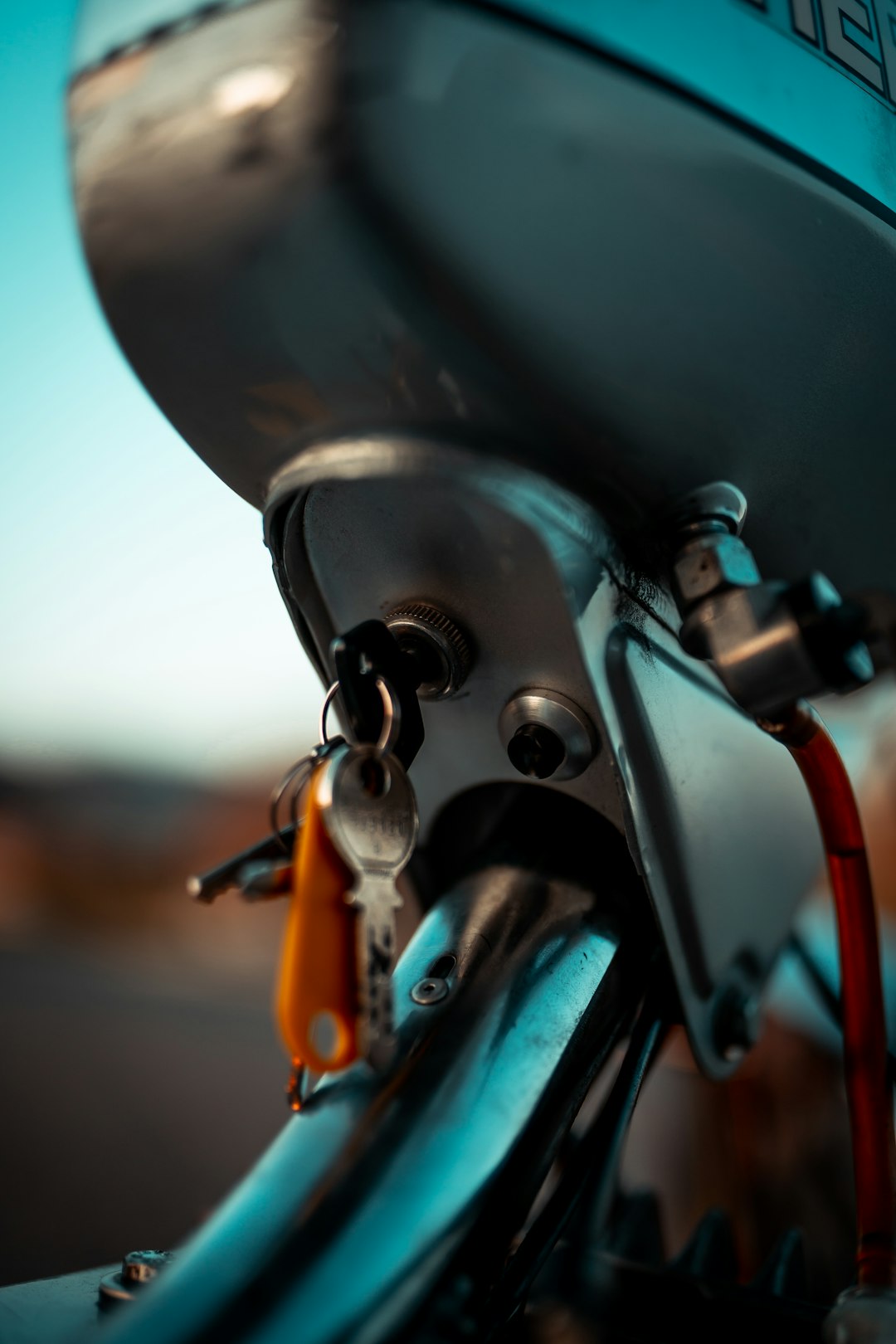 black and silver motorcycle with orange and black handle bar