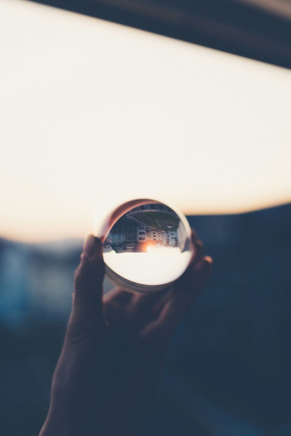 person holding clear glass ball