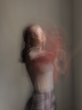 woman in pink shirt and black and white skirt