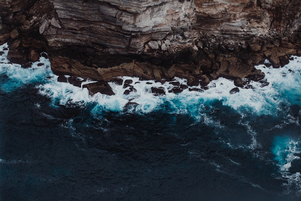 brown rock formation with water