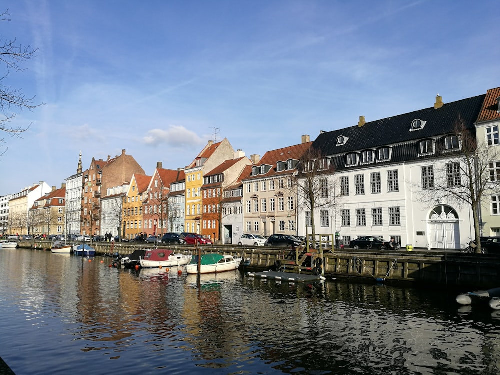 boat on dock near buildings during daytime