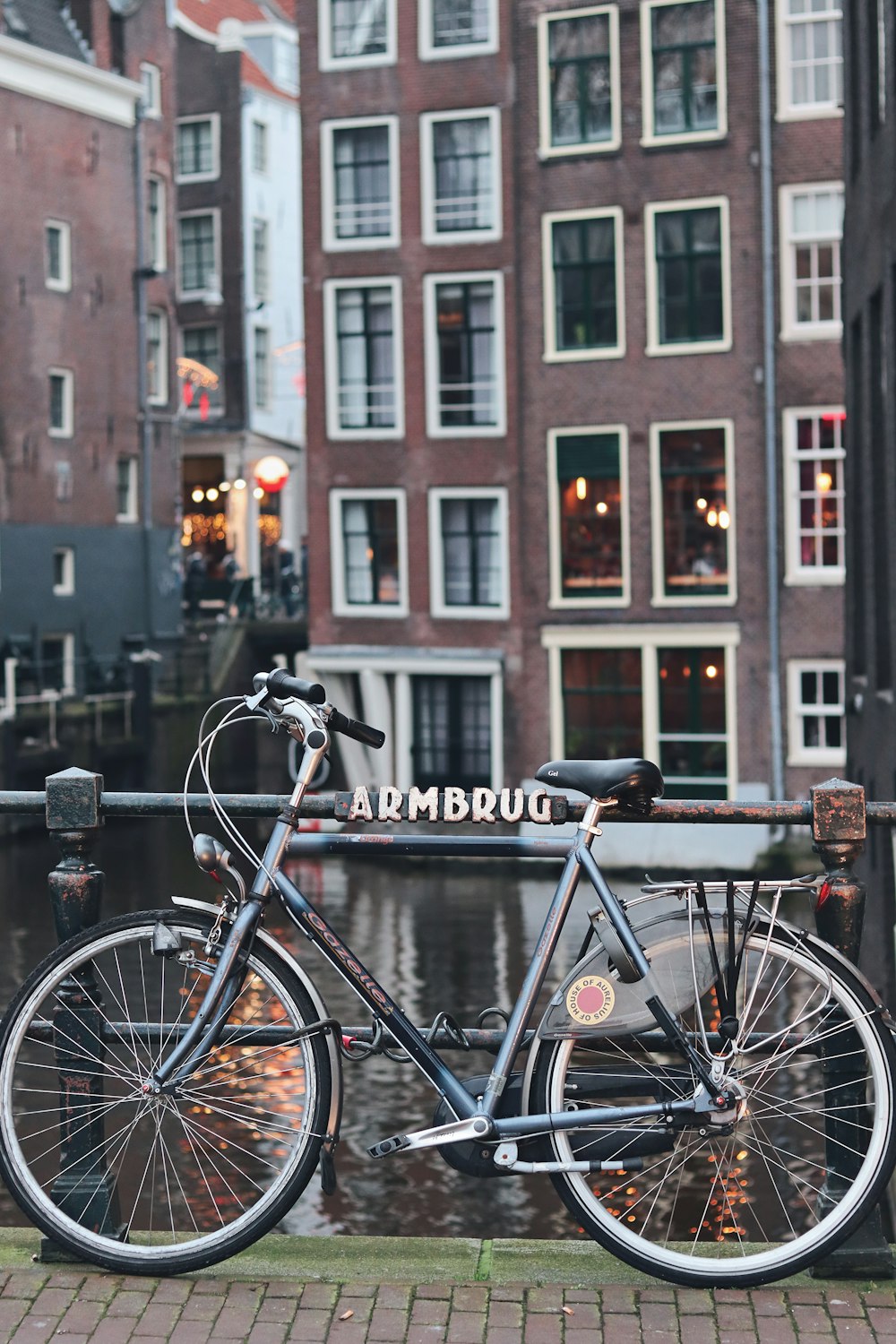 black bicycle parked beside brown concrete building during daytime