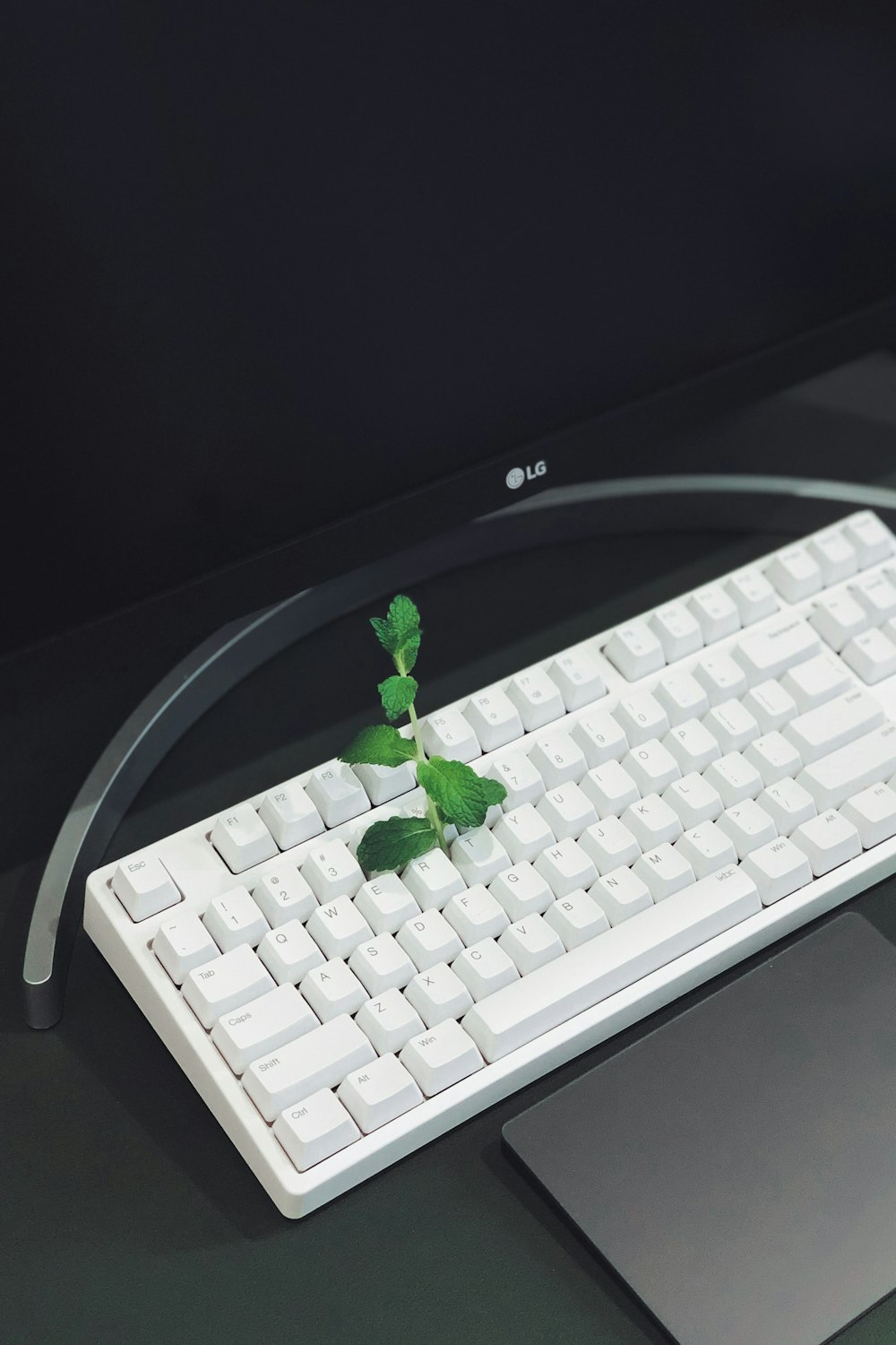 white computer keyboard on black table