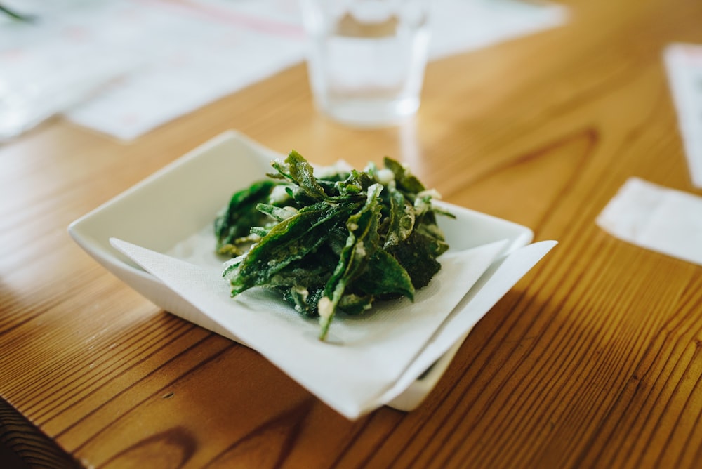 green vegetable on white ceramic plate