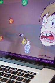 A cartoon-style computer game screen depicts a character with a surprised expression facing several floating virus illustrations. Points are indicated with '+10' near a spray bottle labeled 'Spray & Stay'. The bottom of the screen displays health advice like washing hands and maintaining social distance.