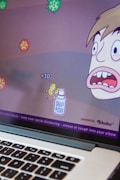 A cartoon-style computer game screen depicts a character with a surprised expression facing several floating virus illustrations. Points are indicated with '+10' near a spray bottle labeled 'Spray & Stay'. The bottom of the screen displays health advice like washing hands and maintaining social distance.