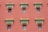 A series of windows with ornate, decorative architectural elements line a red wall. The windows have intricate lattice designs, and above them are detailed cornices painted in green and orange, accented with gold.