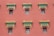 A series of windows with ornate, decorative architectural elements line a red wall. The windows have intricate lattice designs, and above them are detailed cornices painted in green and orange, accented with gold.