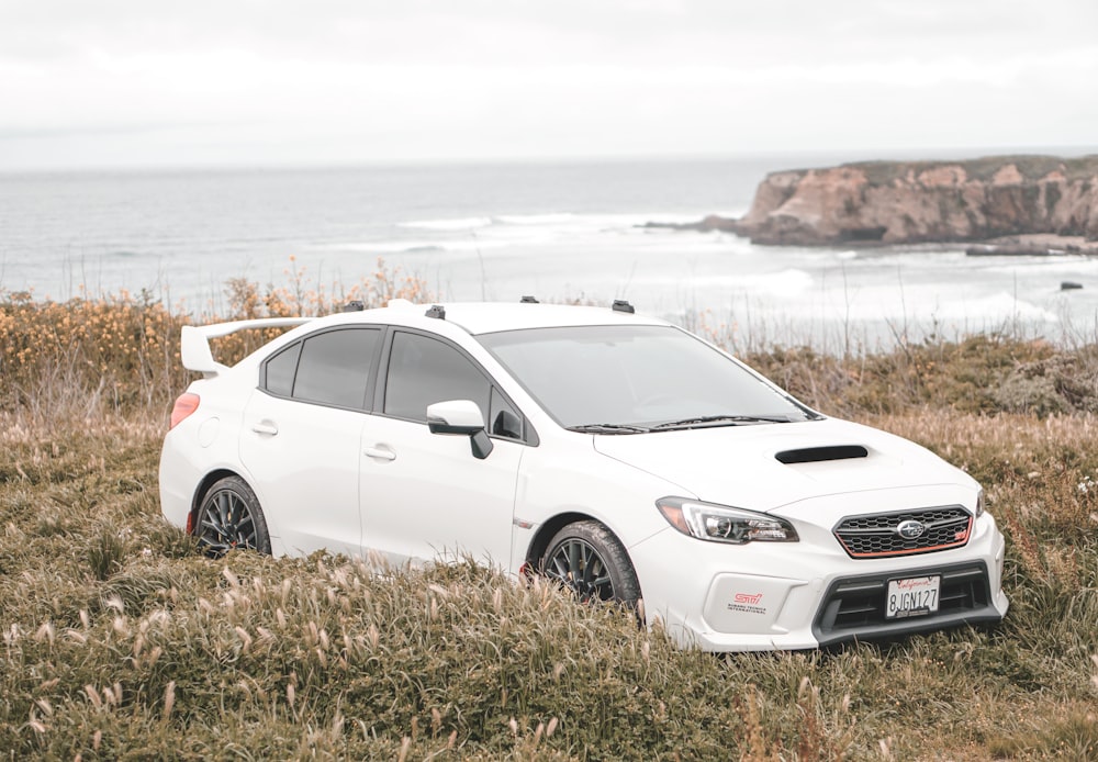 white honda sedan on green grass field during daytime