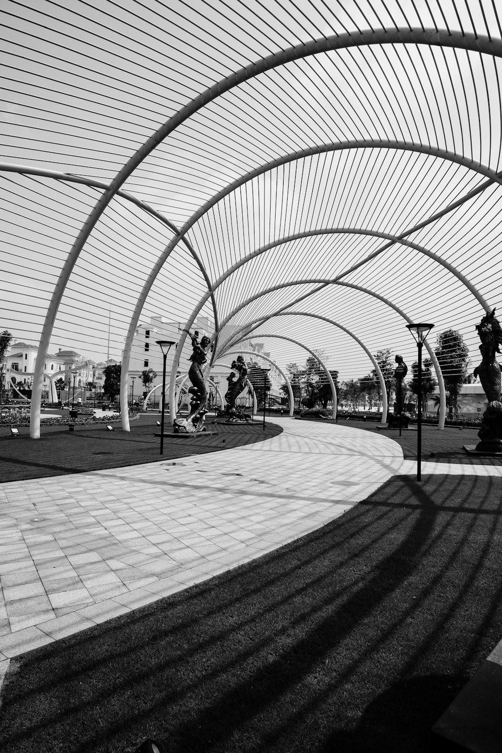 grayscale photo of people walking on pathway