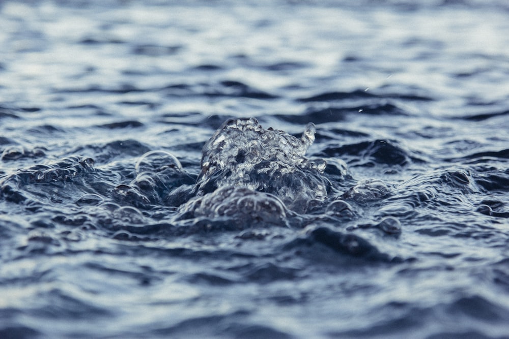 water splash on body of water during daytime