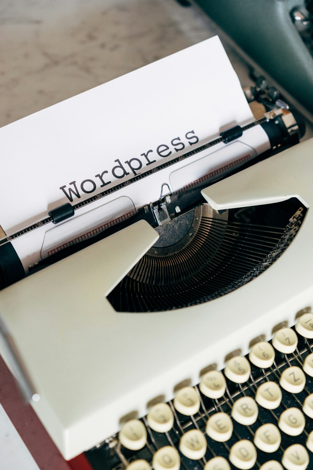 white and black typewriter on white table