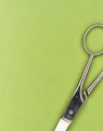 silver scissors on green surface