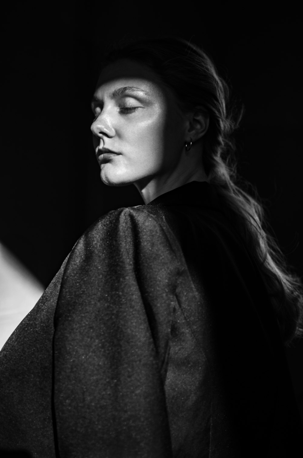 grayscale photo of woman in black coat