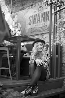 woman in leopard print shirt sitting on wooden chair