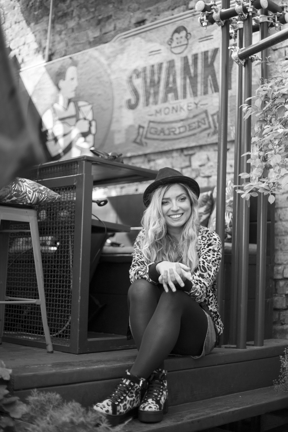 woman in leopard print shirt sitting on wooden chair