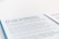A document page with blue and white background text detailing new arrangements for TV licenses for individuals over 75. The text mentions the end of free TV licenses funded by the government and provides information regarding eligibility and application.