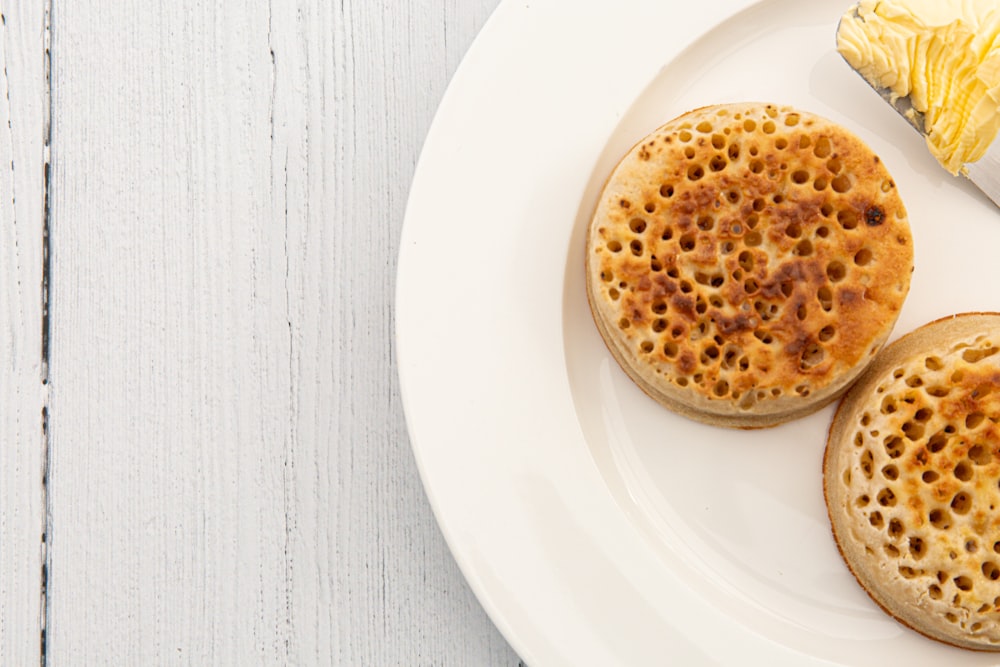 brown and white round pastry on white ceramic round plate