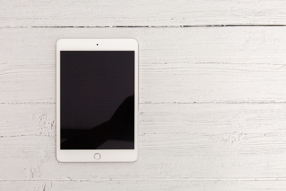 white ipad on white wooden table