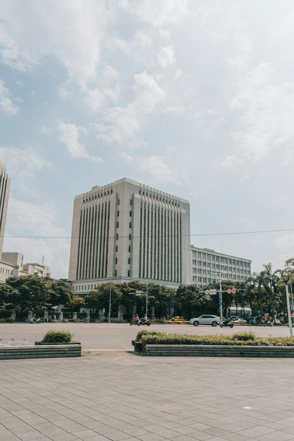 white concrete building near green trees during daytime