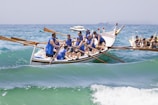 people riding on blue and white boat on sea during daytime