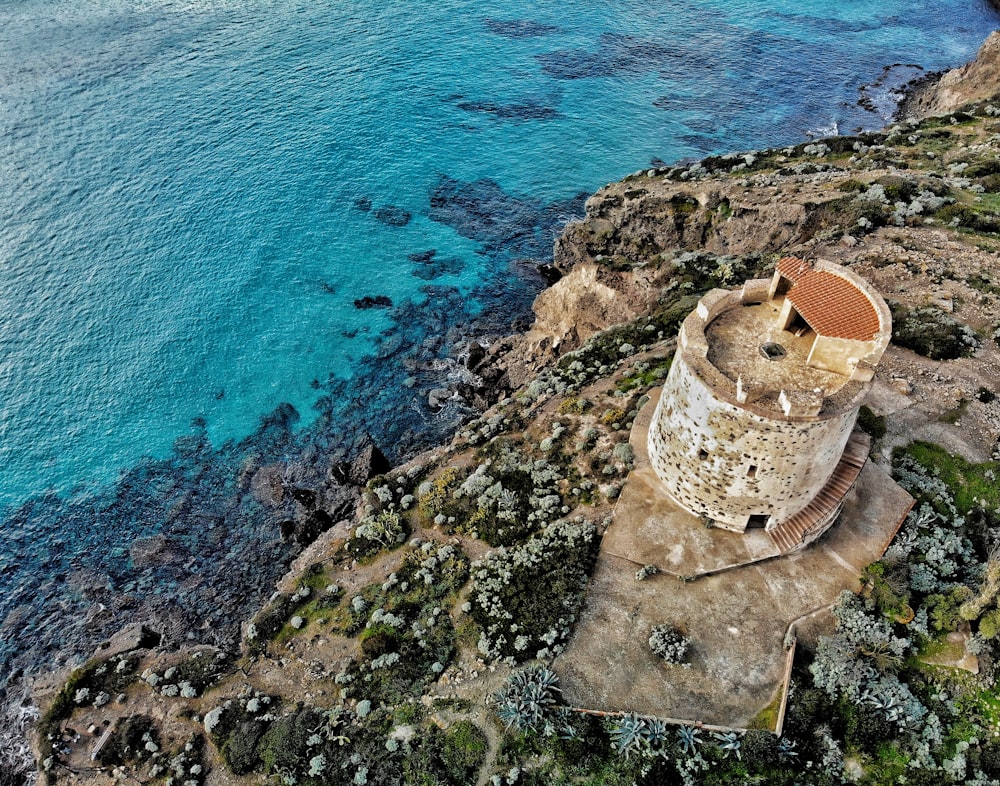 aerial view of brown rock formation on sea during daytime