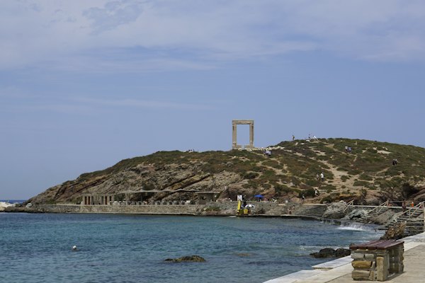 People swimming on sea near brown mountain during daytime — Naxos, Greece