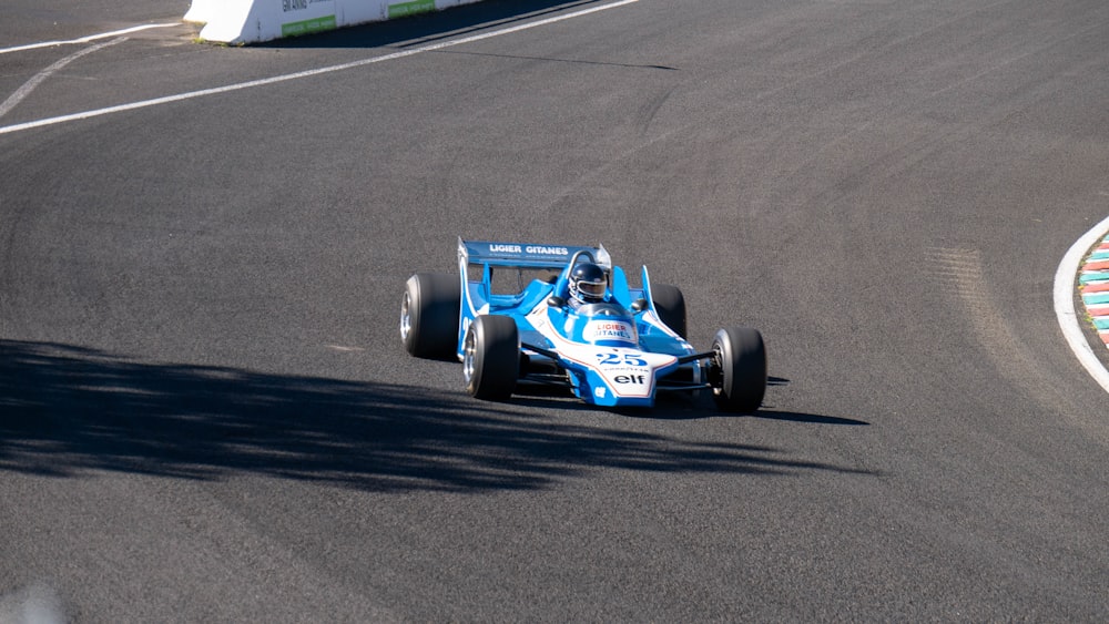 blue and black f 1 car on road