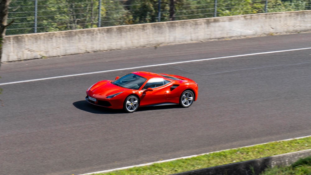 red ferrari 458 italia on road during daytime