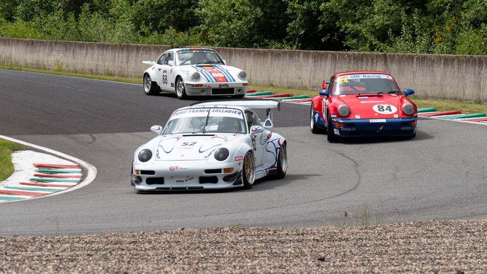 white and red porsche 911 on road during daytime