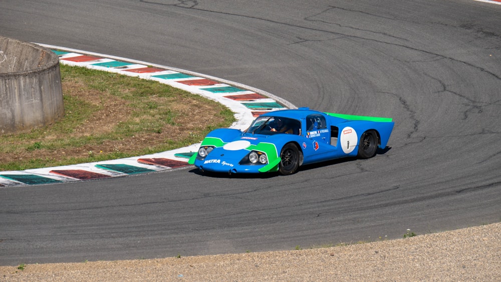 blue and white racing car on track