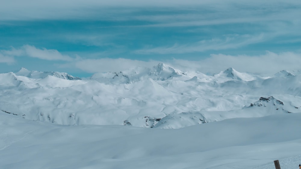 snow covered field under blue sky