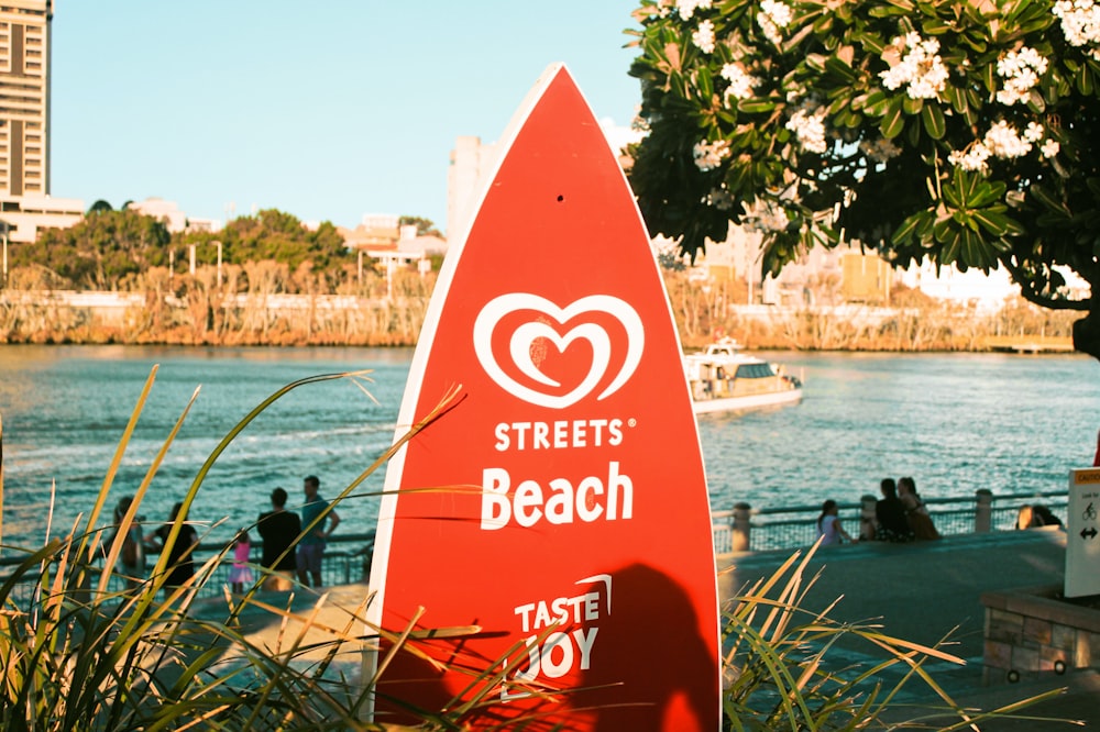 red and white wooden boat on water during daytime