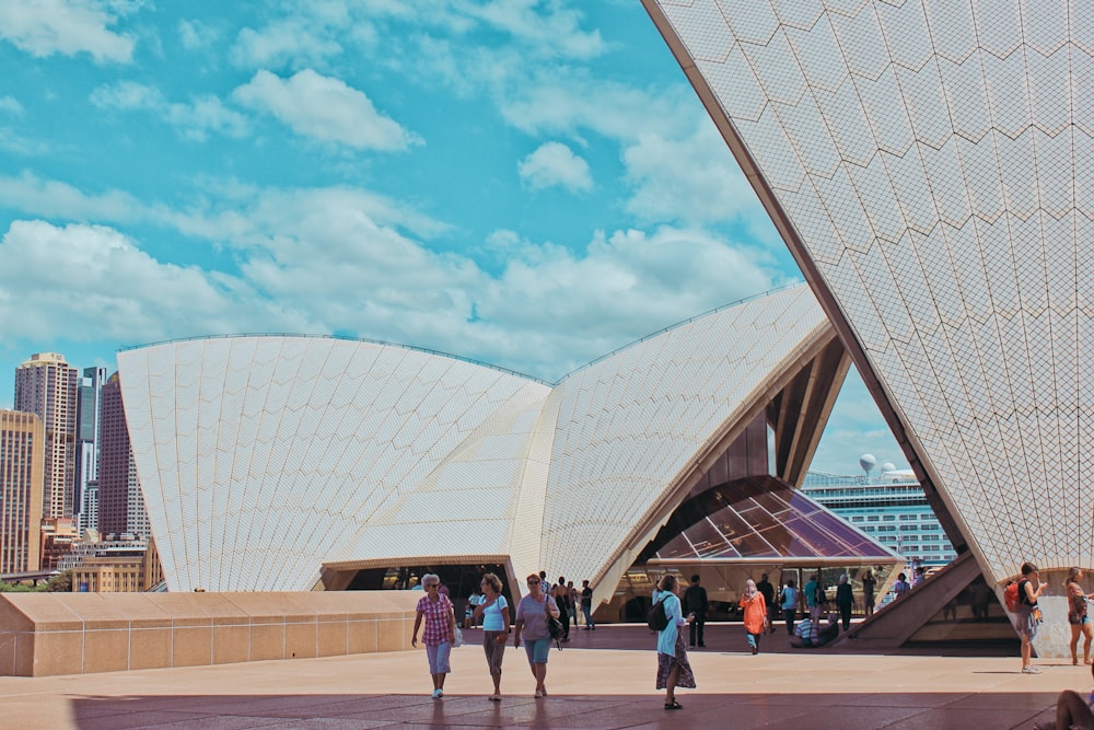 people walking near white concrete building during daytime